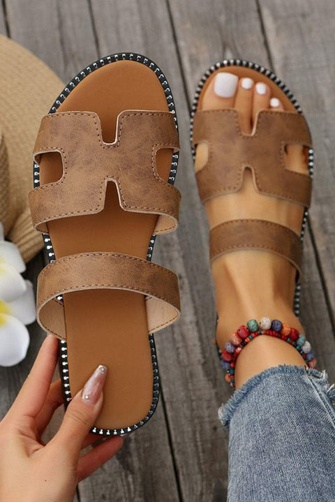 Black leather H band slides with cushioned footbed, perfect for casual or dressy occasions.