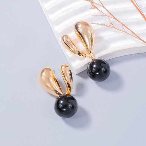 Alloy drip oil bunny earrings with golden ear and black bead design.