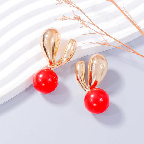 Alloy Drip Oil Bunny Earrings with red bead accents.