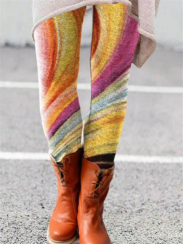 Colorful printed flared trousers with an artistic design paired with brown boots.