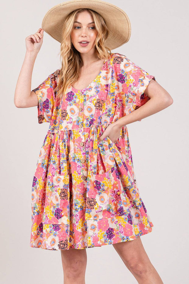 Floral babydoll dress with short sleeves and pockets, showcasing a colorful print and relaxed fit.