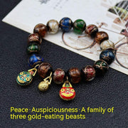Gray Colored Glaze Bracelet with gold charms on a black surface, showcasing rich tones and glossy finish.