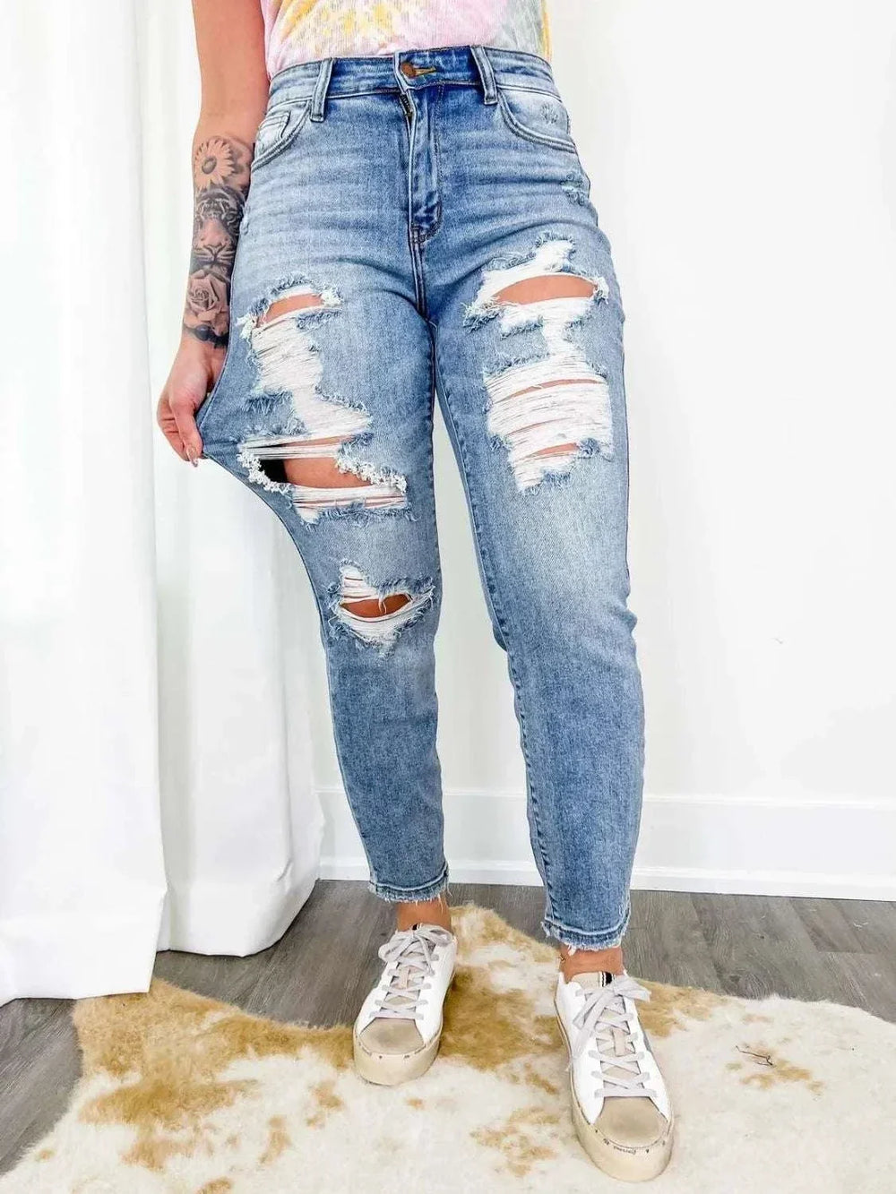 Women's distressed skinny denim jeans with mid-rise fit and stylish ripped detailing from Hot Topic Goods