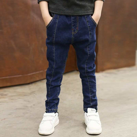 Boys wearing comfortable denim jeans with white sneakers.