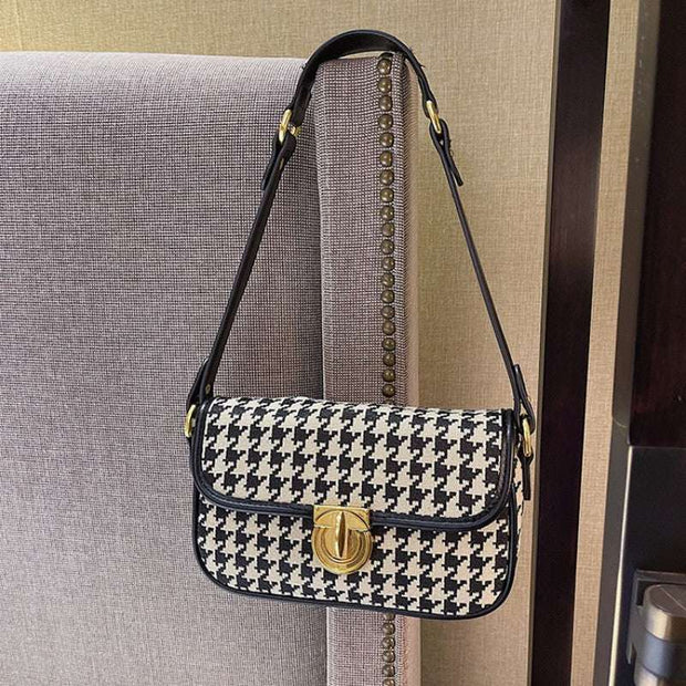 Houndstooth Baguette Bag with classic pattern on a chair.