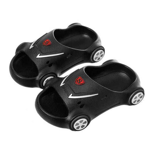 Kids Glowing Slippers shaped like cars in black with white wheels and open toe design.