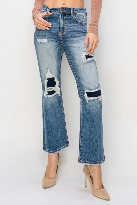 RISEN Distressed Flare Jeans with edgy distressed details and a flattering flare design.