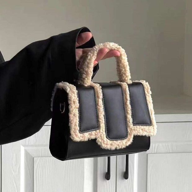 Black lambs wool crossbody bag with PU accents and cozy design.