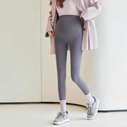 Fleece-lined maternity pants with stretchy waistband and cozy lining, perfect for pregnancy comfort.