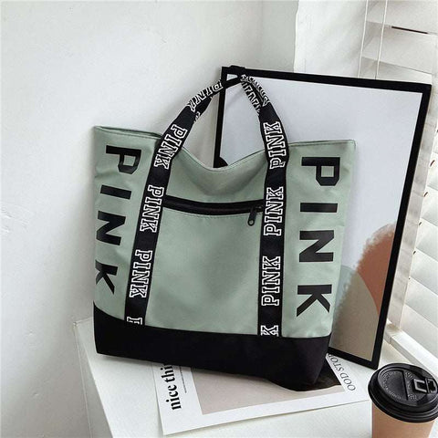 Large Capacity Handbag in green and black with "PINK" text design, featuring durable handles and front zipper pocket.