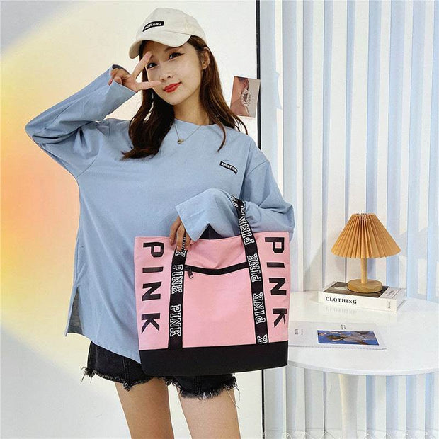 Large Capacity Handbag in pink and black with a casual fashion design.