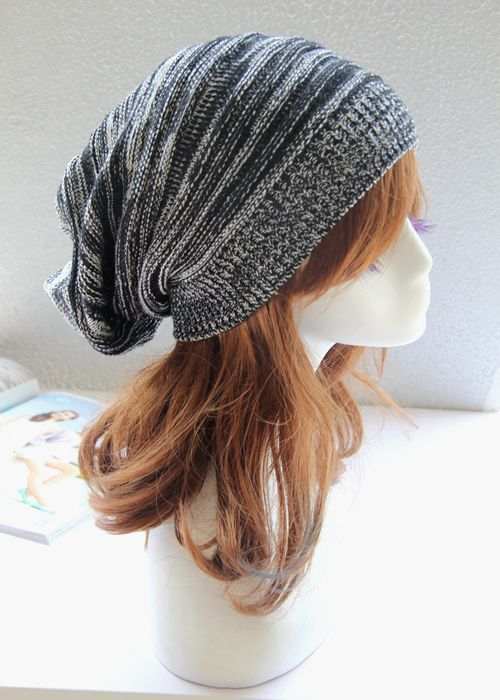 Two-color pleated pullover hat in knit design with black and white pattern displayed on a mannequin.