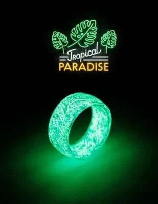 Unisex Luminous Ring glowing in the dark with a tropical design backdrop.