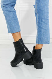 MMShoes Lug Sole Chelsea Boots in black with rugged sole, paired with blue jeans.