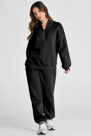 Black quarter zip top and pants set, featuring long sleeves and a chic zip neckline, ideal for casual outings.