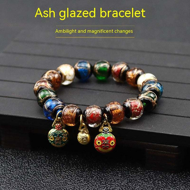 Gray colored glaze bracelet with smooth finish and geometric design, unisex accessory.
