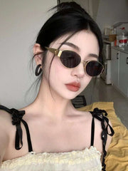 Metal Oval Vintage Sunglasses on model showcasing retro style and chic design.