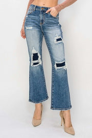 RISEN Distressed Flare Jeans with edgy details and flattering silhouette.