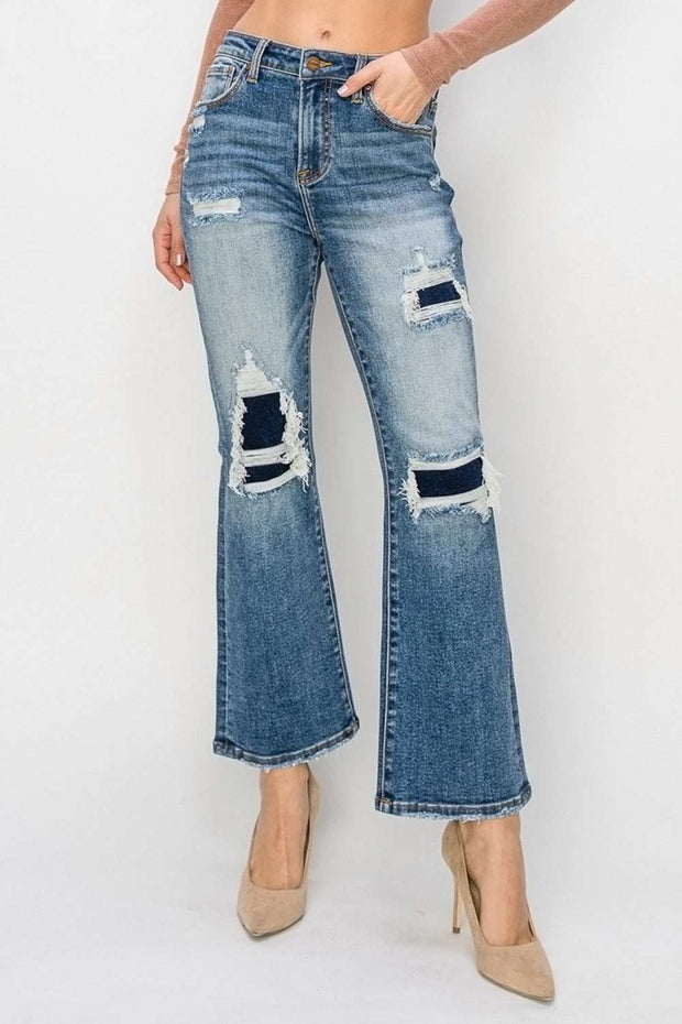 RISEN Distressed Flare Jeans with edgy details and flattering silhouette.