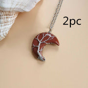 Moon Tree Of Life Necklace with crescent-shaped pendant and tree design on a delicate chain.