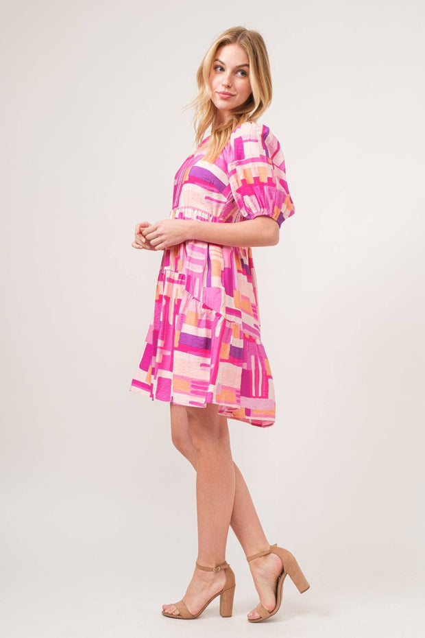 Color Block Puff Sleeve Dress with bold geometric pattern and puff sleeves, styled with neutral heels.