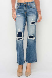 Distressed flare jeans with distressed details and slight stretch for a trendy look.