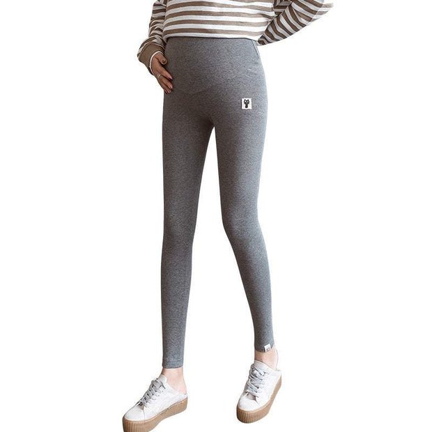 Fleece-lined maternity leggings in dark gray, providing comfort and support for pregnancy.