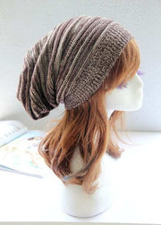 Pleated Pullover Hat in brown and white on mannequin bust.
