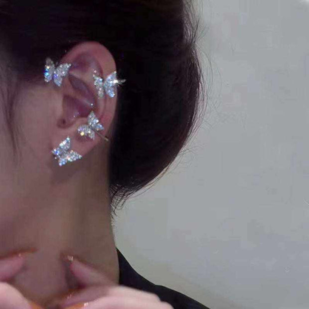 Elegant butterfly ear clip earrings with sparkling design.
