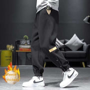 Casual velvet padded pants in black, styled with elastic waistband, showcasing fleece thickness for warmth and comfort.