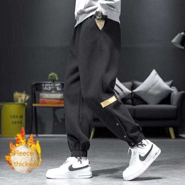 Casual velvet padded pants in black, styled with elastic waistband, showcasing fleece thickness for warmth and comfort.