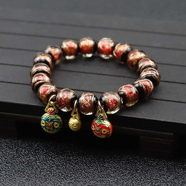 Gray colored glaze bracelet with geometric design and gold accents.