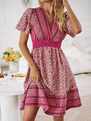 Floral Smocked Waist Mini Dress with short sleeves and vibrant floral print.