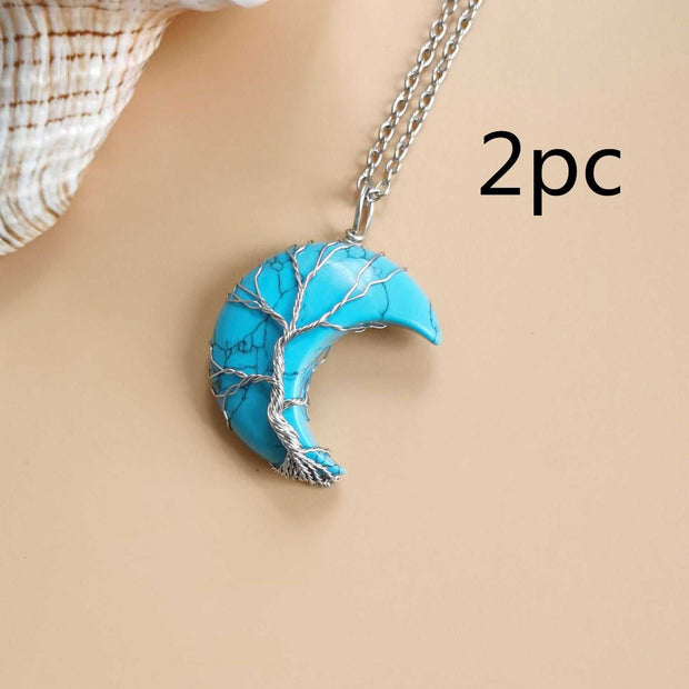 Moon Tree Of Life Necklace with turquoise crescent pendant and tree design on a silver chain.