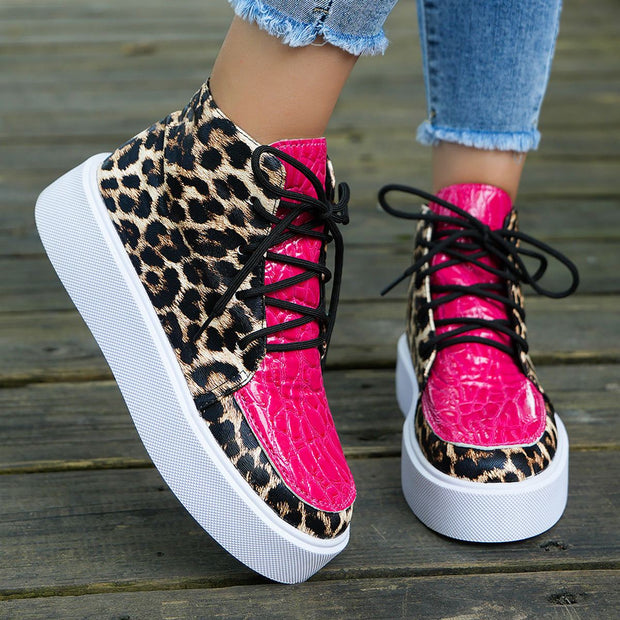 Leather Leopard Platform Sneakers with bold print and pink accents on wooden surface.