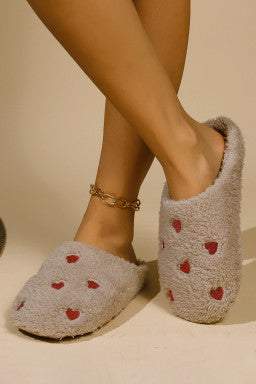 Pink heart embroidered plush slippers with soft, cozy design.
