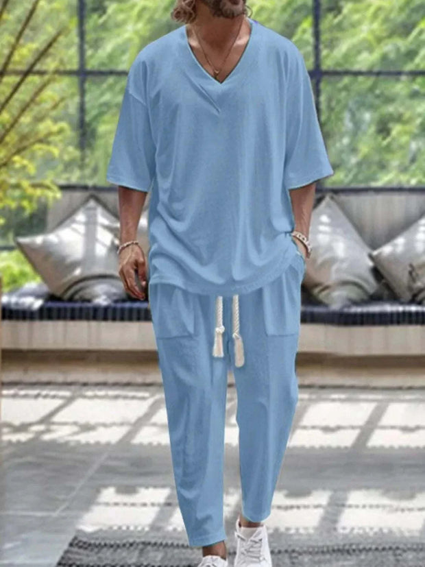 Men's V-neck half sleeve top and pants set in light blue, featuring a relaxed fit and casual style.