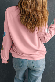 Pink Valentines sweatshirt with graphic print, worn with jeans.