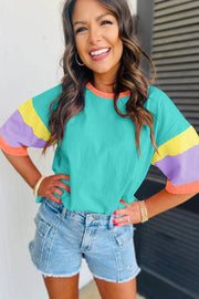 Green Color Block Oversize Top with color block sleeves, round neckline, paired with denim shorts.