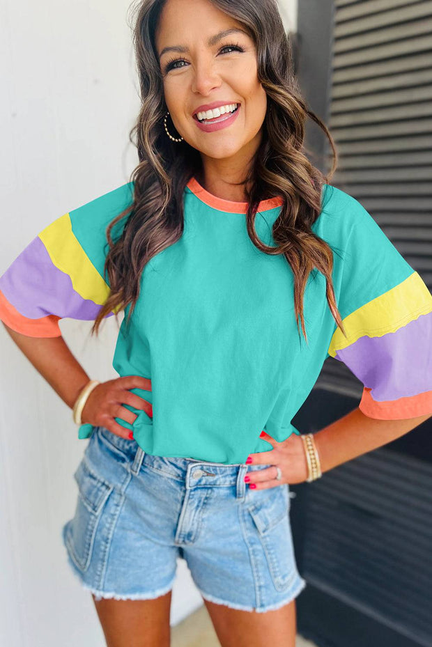 Green Color Block Oversize Top with color block sleeves, round neckline, paired with denim shorts.