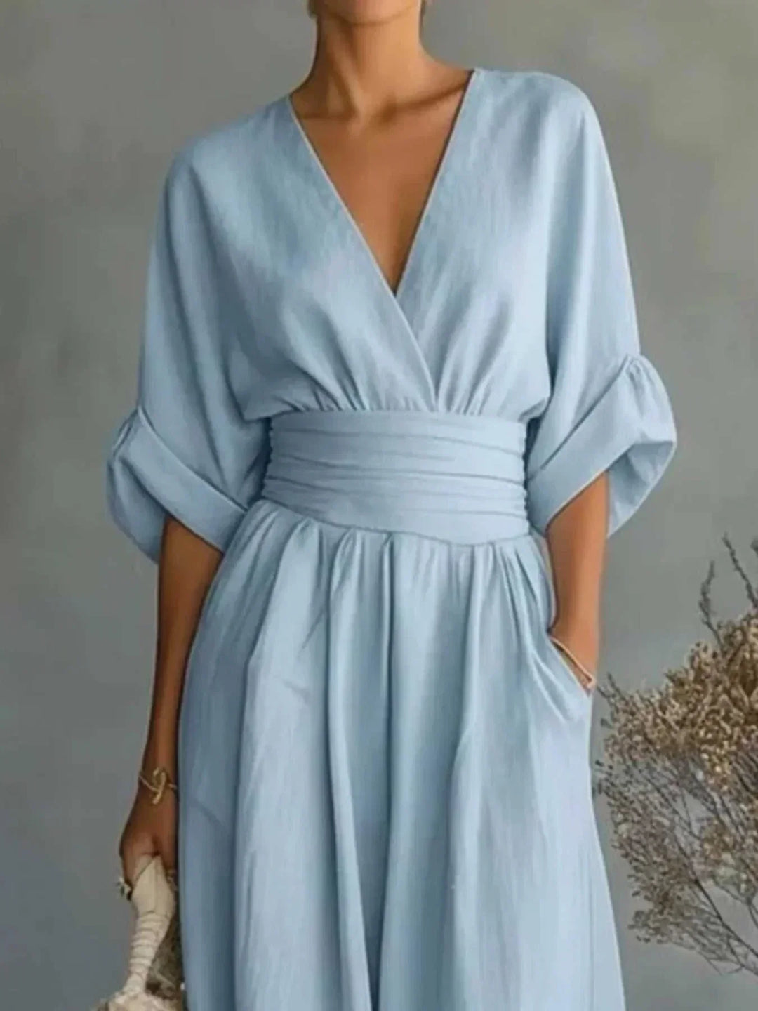 Woman wearing a full-size half sleeve wide leg jumpsuit with V-neckline and relaxed fit