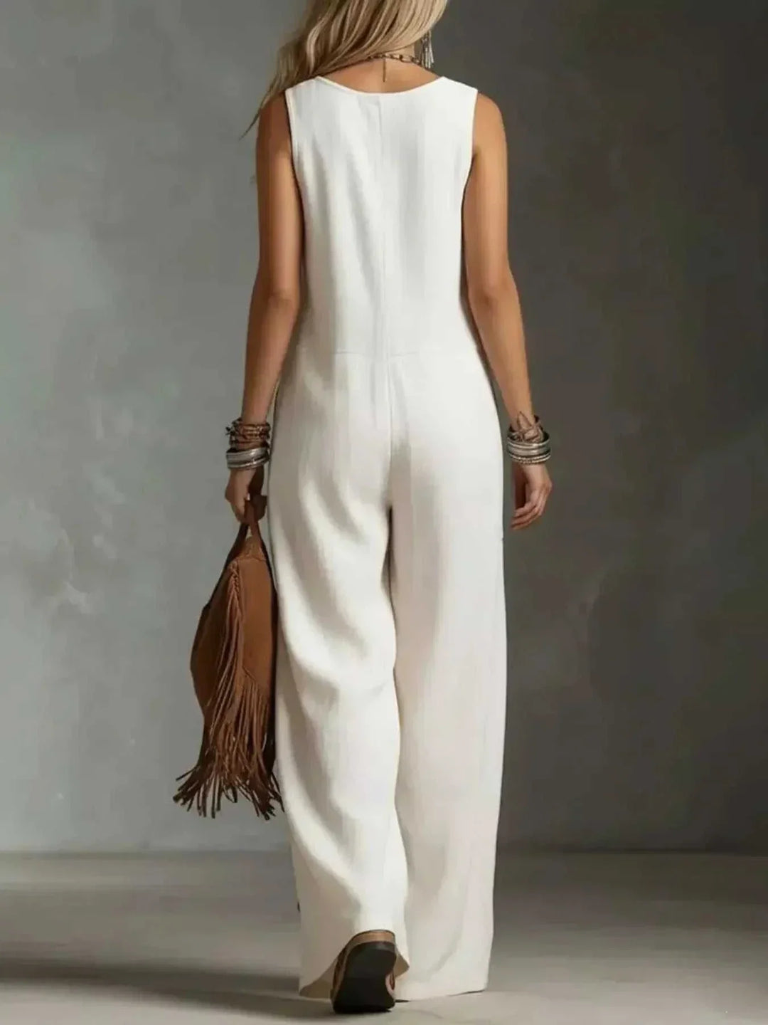 Women wearing full size sleeveless button-front wide leg jumpsuit from Hot Topic Goods