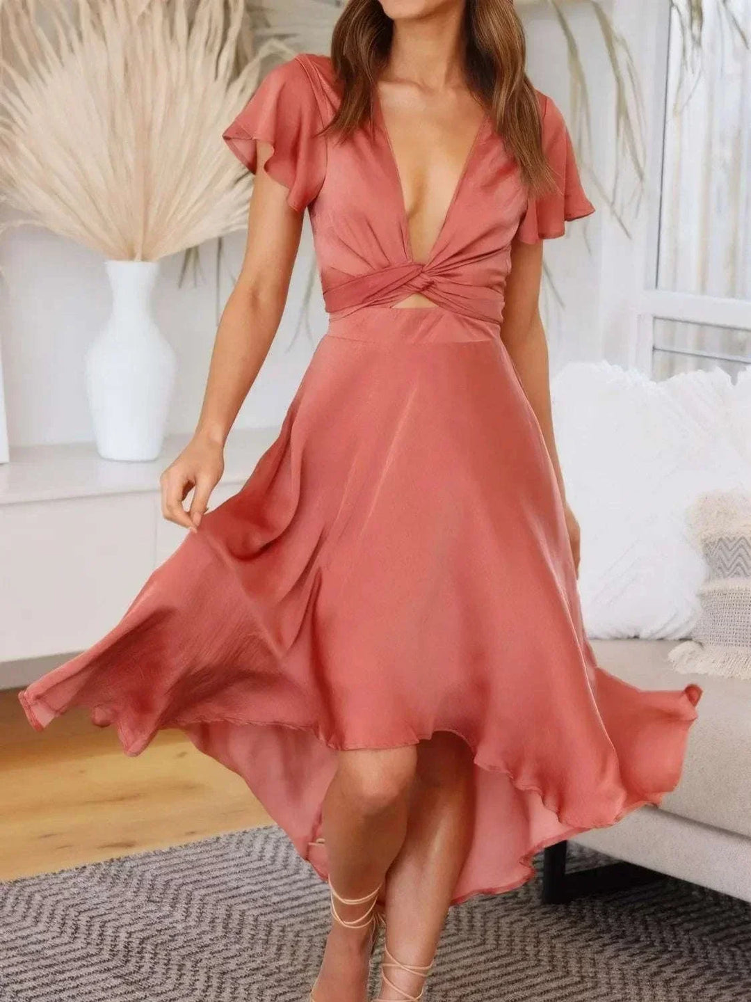 Woman wearing Women's High-Low Plunge Flutter Sleeve Dress with elegant plunge neckline and flowing high-low hemline