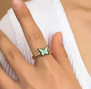 Fidget Spinner Ring with butterfly design worn on finger, stylish accessory for stress relief.