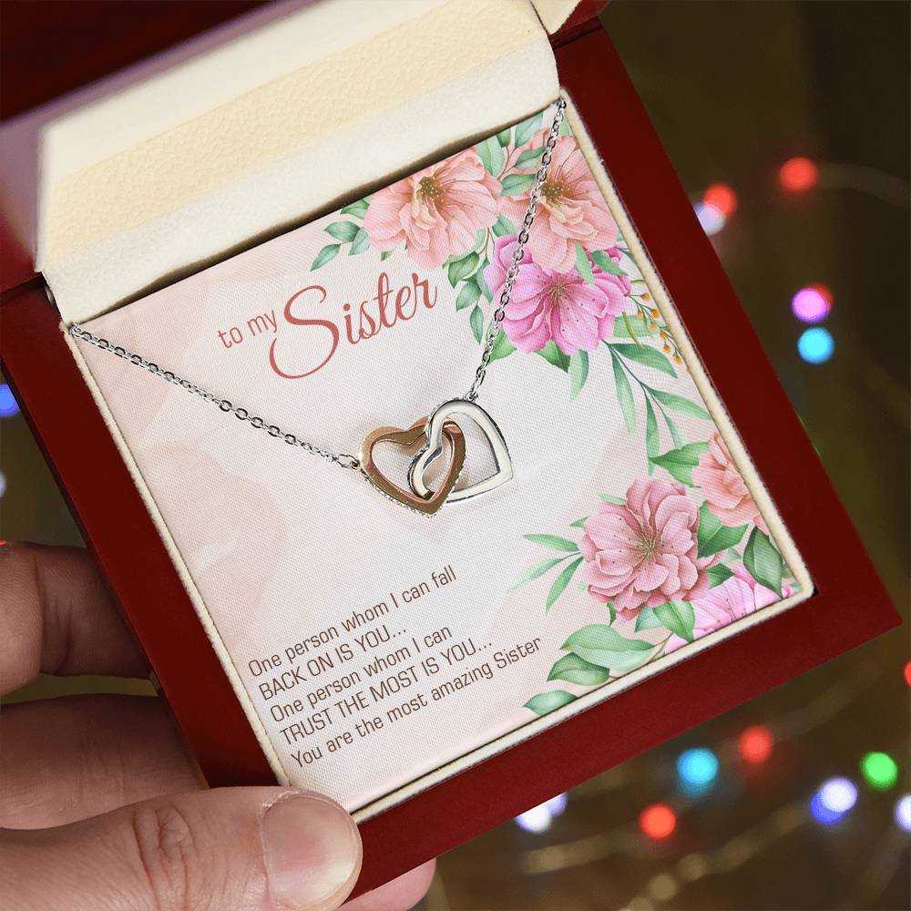 Interlocking Hearts Necklace for Sister with CZ crystals in rose gold and yellow gold, symbolizing love and trust.