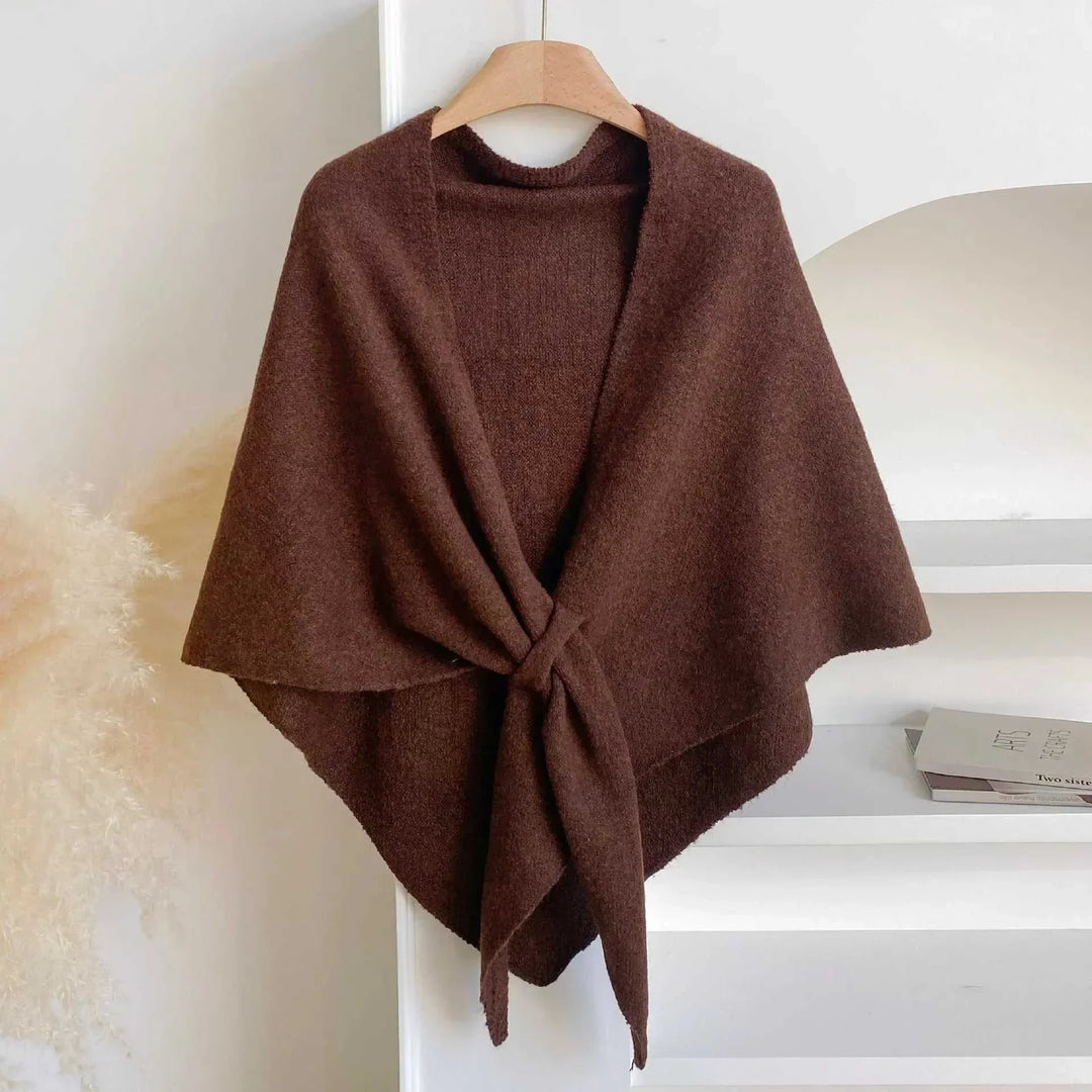 Women's knitted solid color shawl scarf draped over shoulders, soft knit texture, versatile layering accessory from Hot Topic Goods