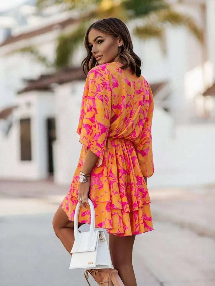 Woman wearing a layered printed surplice mini dress from Hot Topic Goods
