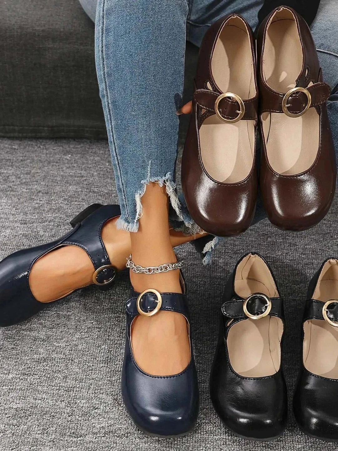 Pair of black Mary Jane buckle loafers with cushioned footbed and adjustable strap for women