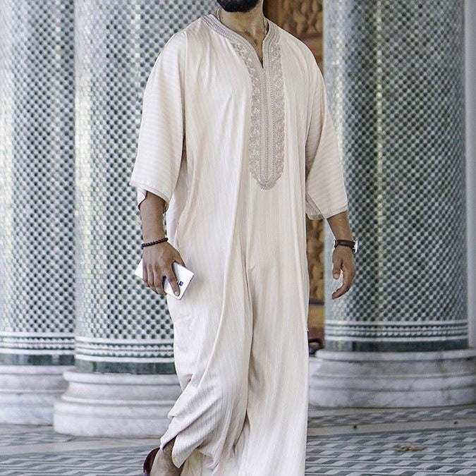 Men's embroidered white Muslim thobe robe with elegant embroidery and relaxed fit from Hot Topic Goods