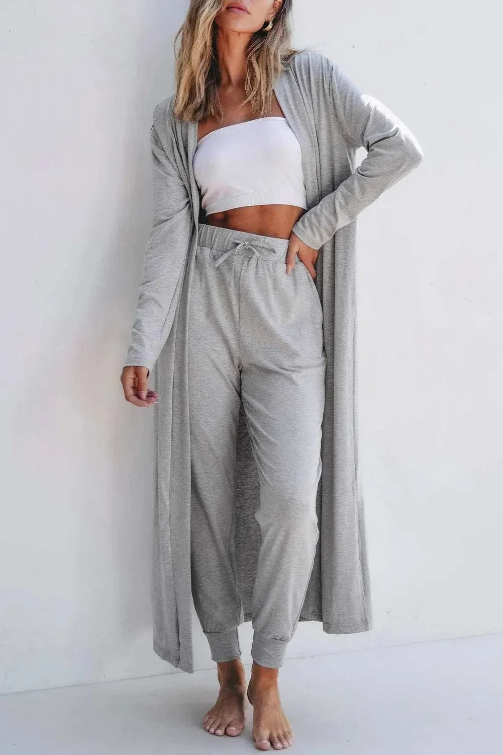Woman wearing Women's Open Front Long Sleeve Cardigan Lounge Set with matching top and pants from Hot Topic Goods